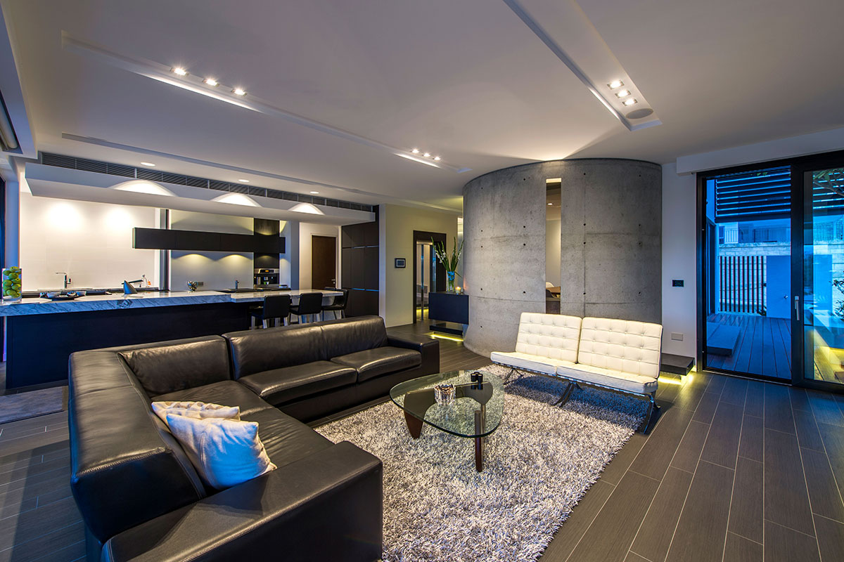 Designer living area with curved form concrete walls, amazing ceiling and lighting