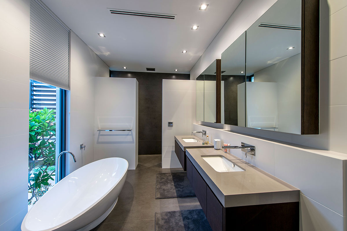 Opulent Designer bathroom with luxurious freestanding bath and Stone floor and benchtops