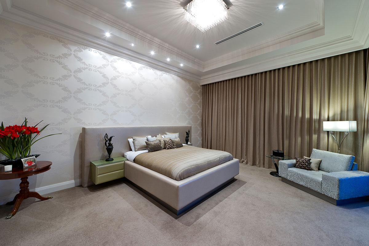 Huge bedroom with luxury curtains, carpets, ceiling mouldings, wallpaper in South perth multi level custom built home by prima designer homes